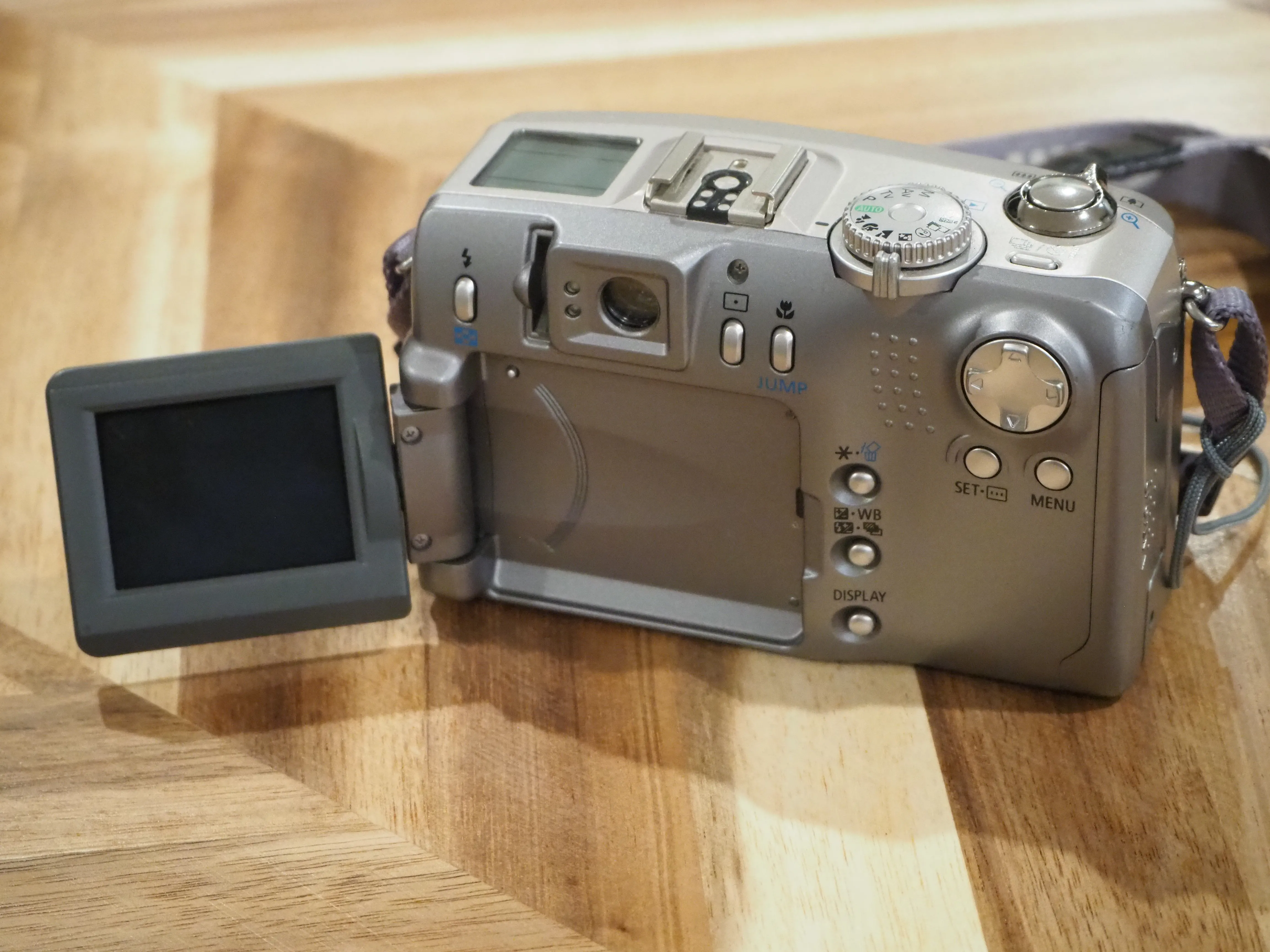 Rear view of the Canon PowerShot G2 with compartments open.